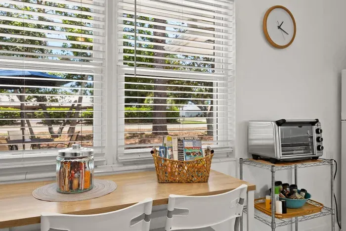 Dinette table for two, welcome brochures, treats for guests, air fryer, and spices.