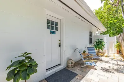 Front entrance with beach chairs.