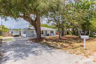 Exterior view of the property with designated parking spot (green square) and pin point that shows the side of the home (around corner) guests access property.