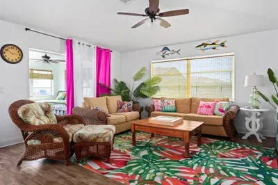 Step into a splash of sunshine! This vibrant lounge features tropical prints, comfy wicker seating, and playful coastal décor. With bright natural light, bold colors, and relaxed vibes, it's the perfect spot to unwind after a day by the pool or beach