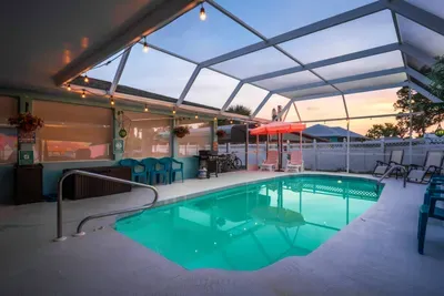 Unwind in your private screened-in pool area, perfect for a morning dip or a sunset swim under glowing string lights.