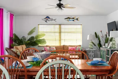 Enjoy meals and memories in this open-concept living and dining space, where vibrant island décor and cozy wicker seating set the tone for your getaway. It’s the perfect space to come together after a day in the sun!