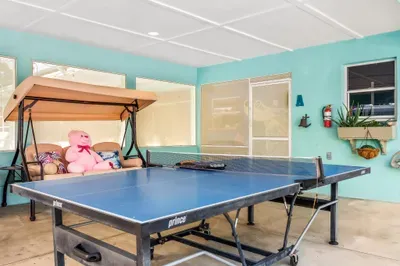 Step into your own private hangout zone—perfect for family fun or friendly competition! This covered patio features a full-size ping pong table ready for action, along with a cozy swing bench to kick back and relax between games.