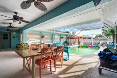 Step into your private Florida oasis, where indoor comfort meets outdoor fun! This bright and breezy screened-in lanai features a sparkling pool, plenty of loungers, and a dining area perfect for enjoying meals al fresco.