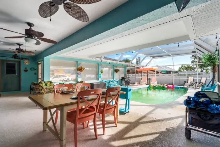 Step into your private Florida oasis, where indoor comfort meets outdoor fun! This bright and breezy screened-in lanai features a sparkling pool, plenty of loungers, and a dining area perfect for enjoying meals al fresco.