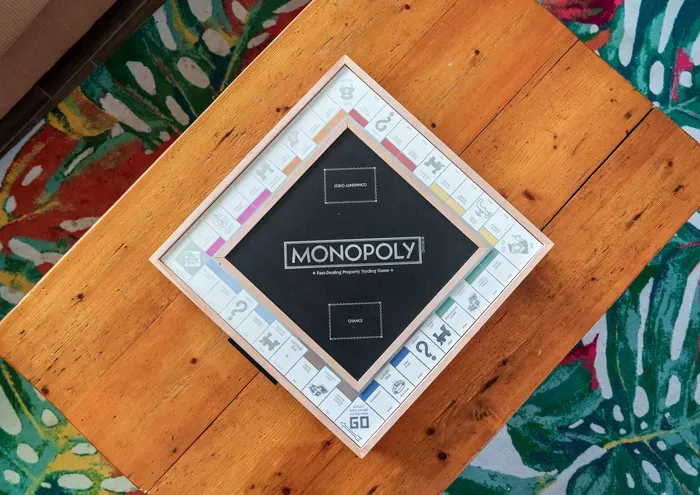 Unwind with a cozy game night around our rustic wooden coffee table, featuring classic favorites like Monopoly.