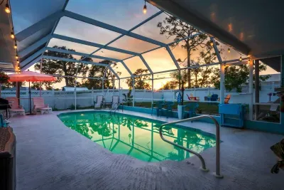 Soak in the golden hues of sunset from this screened-in, heated pool area, the centerpiece of your vacation escape.