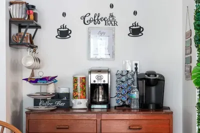 Fuel your beach days at our fully stocked coffee bar! This stylish setup includes both a Keurig and a traditional brewer, a wide selection of K-Cups, creamers, teas, and even a candy dispenser for an extra treat.