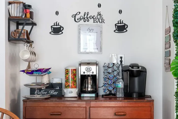 Fuel your beach days at our fully stocked coffee bar! This stylish setup includes both a Keurig and a traditional brewer, a wide selection of K-Cups, creamers, teas, and even a candy dispenser for an extra treat.