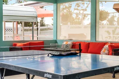 Unwind or challenge your travel companions to a friendly game in this vibrant outdoor oasis! Surrounded by string lights and open-air windows, this is your go-to space for fun, fresh air, and memorable moments.