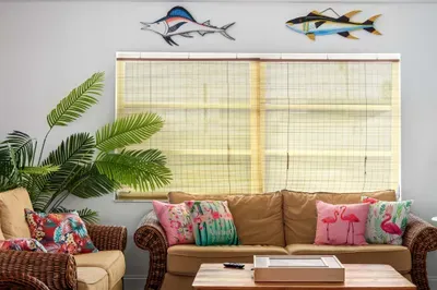 Unwind in this vibrant, tropical-inspired nook! With comfy wicker seating, bold palm and flamingo pillows, and playful fish décor, this space is perfect for morning coffee, afternoon naps, or evening chats.