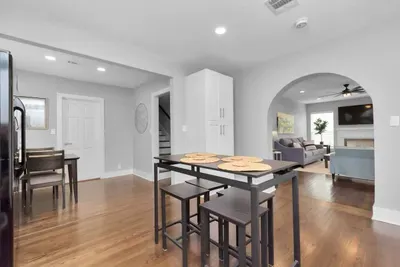 Kitchen view opening up to living room and dining area.