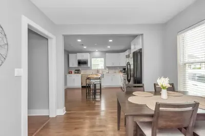 Kitchen opens to the dining room and equipped with basic utensils and cookware.