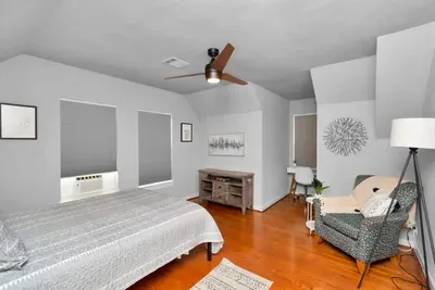 Bedroom 2 with queen size-bed, lounge area, and designated work space.
