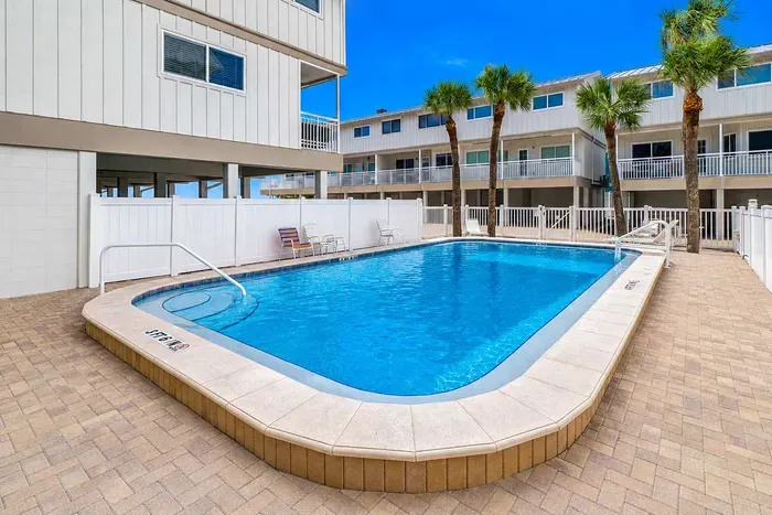 The villa pool - palm-shaded, sun-drenched, and shared with your building neighbors. A soft landing between beach mornings and sunset walks.