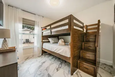 Fun and cozy bunk bedroom perfect for kids or extra guests! Featuring sturdy wooden bunks, soft linens, and bright natural light—this playful space offers comfort, convenience, and a great night’s sleep after full days of adventure.