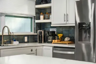 Cook with ease in this fully equipped, modern kitchen featuring stainless steel appliances, sleek countertops, and thoughtful touches throughout. Perfect for preparing meals, morning coffee, or entertaining with friends.