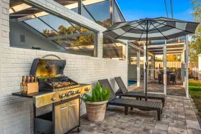 Fire up the grill on the spacious patio with lounge chairs, umbrella shade, and screened comfort. Perfect for outdoor dining, sunbathing, or evening BBQs while enjoying fresh air in a private, relaxing setting.