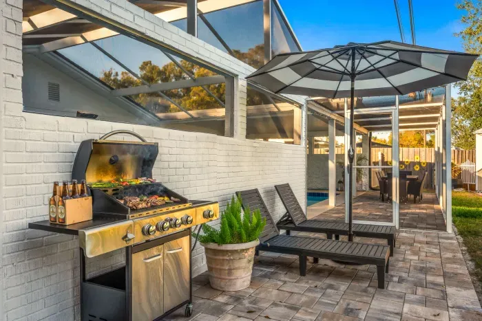 Fire up the grill on the spacious patio with lounge chairs, umbrella shade, and screened comfort. Perfect for outdoor dining, sunbathing, or evening BBQs while enjoying fresh air in a private, relaxing setting.