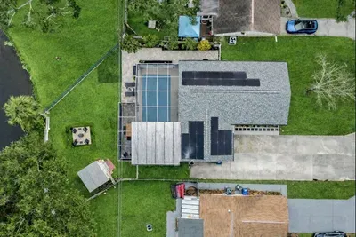 Bird’s-eye view of your private retreat featuring a screened pool, spacious patio, fire pit lounge, and ample parking. Designed for relaxation and fun, this well-laid-out property offers seamless indoor-outdoor living for memorable stays.