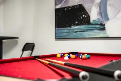 Rack up the fun in this entertainment room featuring a vibrant pool table and casual seating. Perfect for friendly matches, relaxed hangouts, and memorable game nights with family or friends during your stay.