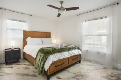 Relax in this bright, spacious bedroom with a comfortable bed, soft linens, and plenty of natural light. A peaceful retreat designed for rest, comfort, and a truly relaxing stay.