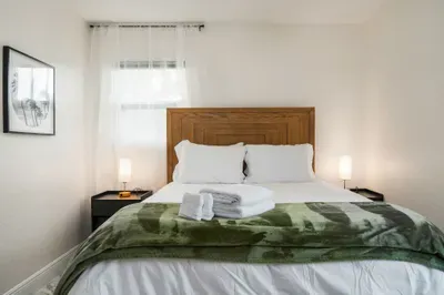 Enjoy a restful stay in this cozy, sunlit bedroom with a comfortable bed, soft linens, and peaceful décor. Thoughtfully designed for relaxation, it’s the perfect place to recharge.