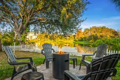 Relax by the lakeside fire pit with Adirondack seating and serene water views. Enjoy sunset conversations, crisp evening air, and cozy nights gathered around the flames in this peaceful outdoor retreat.