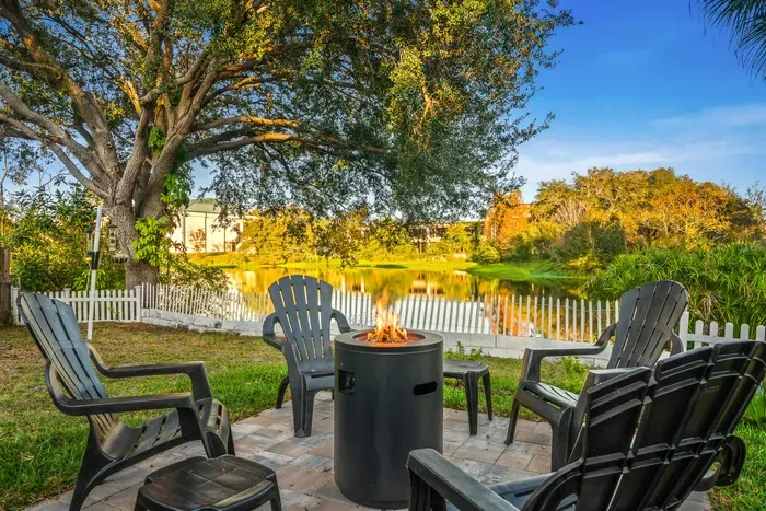 Relax by the lakeside fire pit with Adirondack seating and serene water views. Enjoy sunset conversations, crisp evening air, and cozy nights gathered around the flames in this peaceful outdoor retreat.