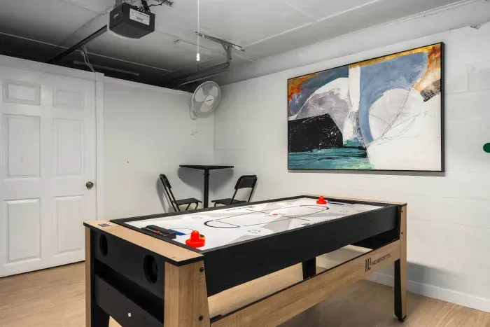 Have fun in the game room featuring a modern shuffleboard table and casual seating. A perfect spot for friendly competition, laid-back hangouts, and entertaining evenings during your stay.