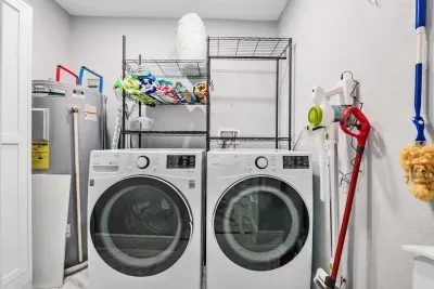 Convenient laundry room with full-size washer and dryer, ample shelving, and essentials for extended stays. Keep clothes fresh and travel light while enjoying the comfort and ease of a well-equipped home-away-from-home.