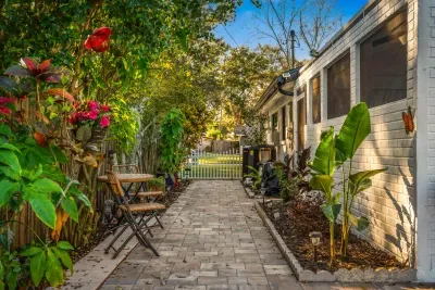 Stroll through this lush garden walkway lined with tropical plants and cozy seating. A peaceful path leading to outdoor relaxation, perfect for quiet mornings, fresh air, and enjoying the home’s serene surroundings.