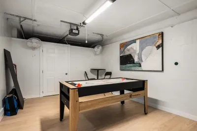 Challenge your group in this dedicated game room with a sleek shuffleboard table and open space to relax. Designed for fun and friendly competition, it’s a great spot for game nights and downtime.