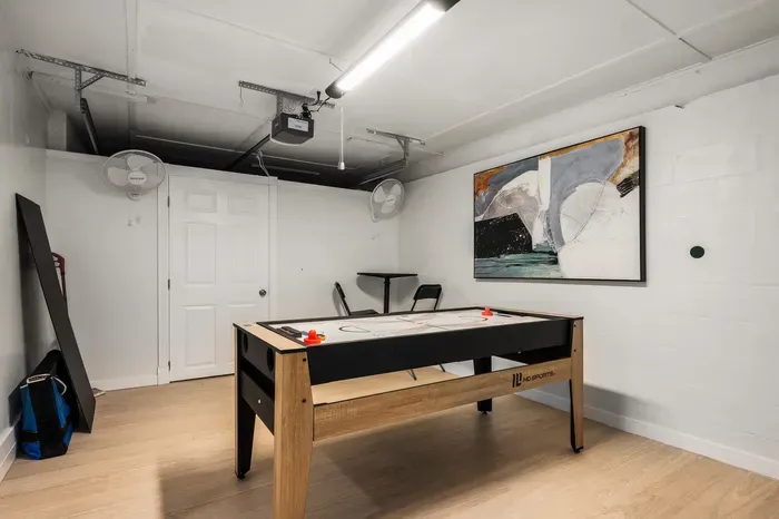 Challenge your group in this dedicated game room with a sleek shuffleboard table and open space to relax. Designed for fun and friendly competition, it’s a great spot for game nights and downtime.