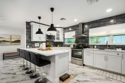 Experience this bright, chef-inspired kitchen with a large island, bar seating, and sleek modern finishes. Fully equipped and spacious, it’s perfect for cooking, entertaining, and gathering with ease.