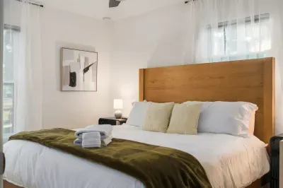 Unwind in this inviting bedroom featuring a plush bed, crisp linens, and calming décor. Filled with natural light, it’s a serene space perfect for rest and a great night’s sleep.