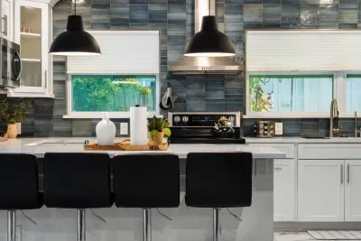 Gather around the spacious kitchen island with bar seating, stylish pendant lighting, and a bright, modern design. Perfect for casual meals, morning coffee, or socializing while cooking together.