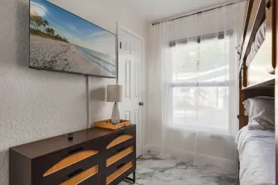 This inviting bedroom offers a comfortable bed, smart TV, and bright natural light. Thoughtfully furnished for comfort and convenience, it’s an ideal space to relax, unwind, and enjoy a peaceful stay.
