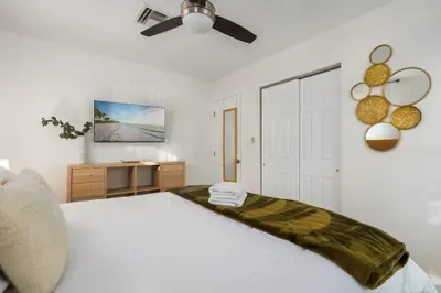 Settle into this tranquil bedroom featuring a comfortable bed, smart TV, and modern touches throughout. Designed for relaxation and convenience, it’s an inviting space to rest and recharge.