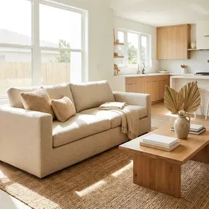 Sun-drenched living room with minimalist furniture and modern kitchen