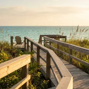 Wooden boardwalk leads to a beach chair by the ocean