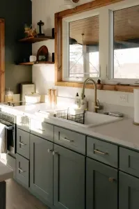 Everything you need, nothing you don’t — a fully stocked kitchen with spices, dishes, a two-burner stovetop, microwave oven combo, mini fridge, and deep sink for slow, simple meals. 