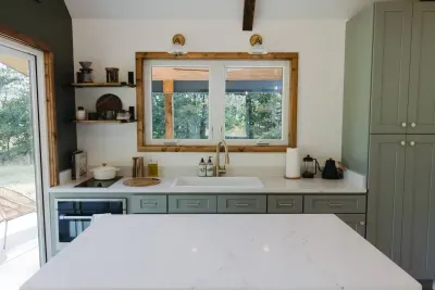 The island provides plenty of space for cooking, as well as dining. (Mini fridge is in the tall cabinet on the right). The kitchen is well-stocked with everything you need to cook a cozy meal!