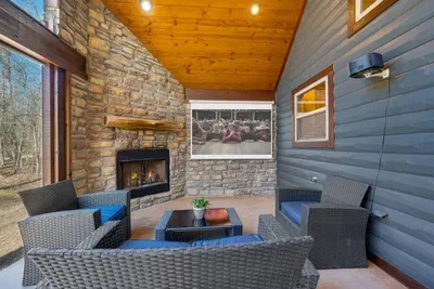 Back Porch: Relax by the fireplace and enjoy movie nights under the stars!