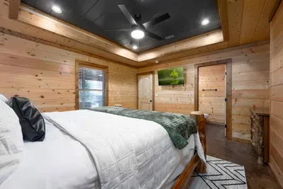 Bedroom Retreat: Unwind in this warm wooden sanctuary featuring rustic charm and serene views!