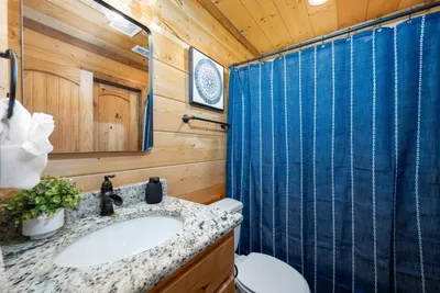 Bathroom Retreat: Modern amenities meet rustic charm in this stylish bathroom oasis!