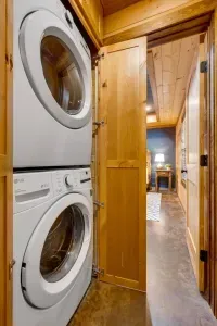 Laundry Room: Efficient appliance combo tucked behind warm wood, making chores a breeze!