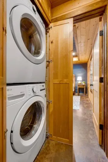 Laundry Room: Efficient appliance combo tucked behind warm wood, making chores a breeze!