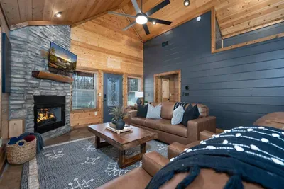Living Room: Elegant leather seating, pull-out couch to that turns into a bed and a warm fireplace set the stage for memorable gatherings!