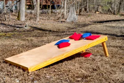 Fun Outdoor Game Area: Challenge friends to a thrilling cornhole tournament in nature!